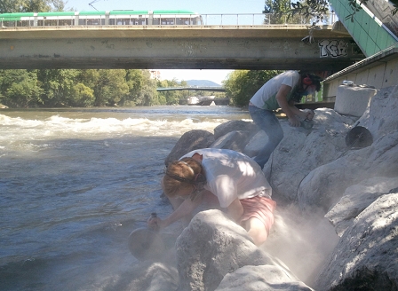 Steinstaub fliegt durch die Luft an der Mur, wenn White Elephant Steine mit der Flex bearbeiten.